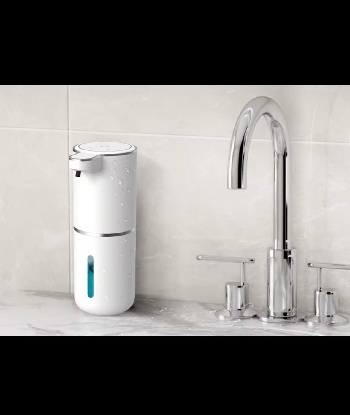 Automatic soap dispenser beside a bathroom sink